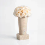Beige marble vase with cream roses, sophisticated floral design on white