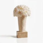 Tall light beige vase with white peony-like flowers, elegant floral design