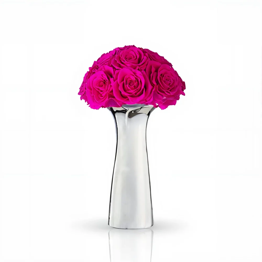 Polished metal vase with vibrant pink roses, modern floral composition