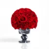 Glossy black marble vase with deep red roses, luxurious floral bouquet