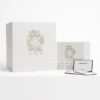 Two large square white boxes with ornate design representing luxury product packaging