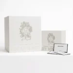 Two large square white boxes with ornate design representing luxury product packaging