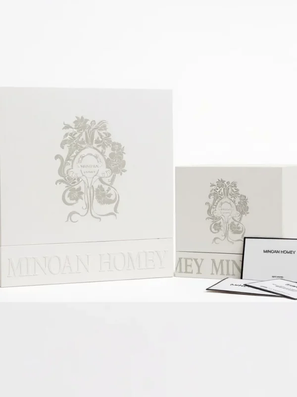 Two large square white boxes with ornate design representing luxury product packaging