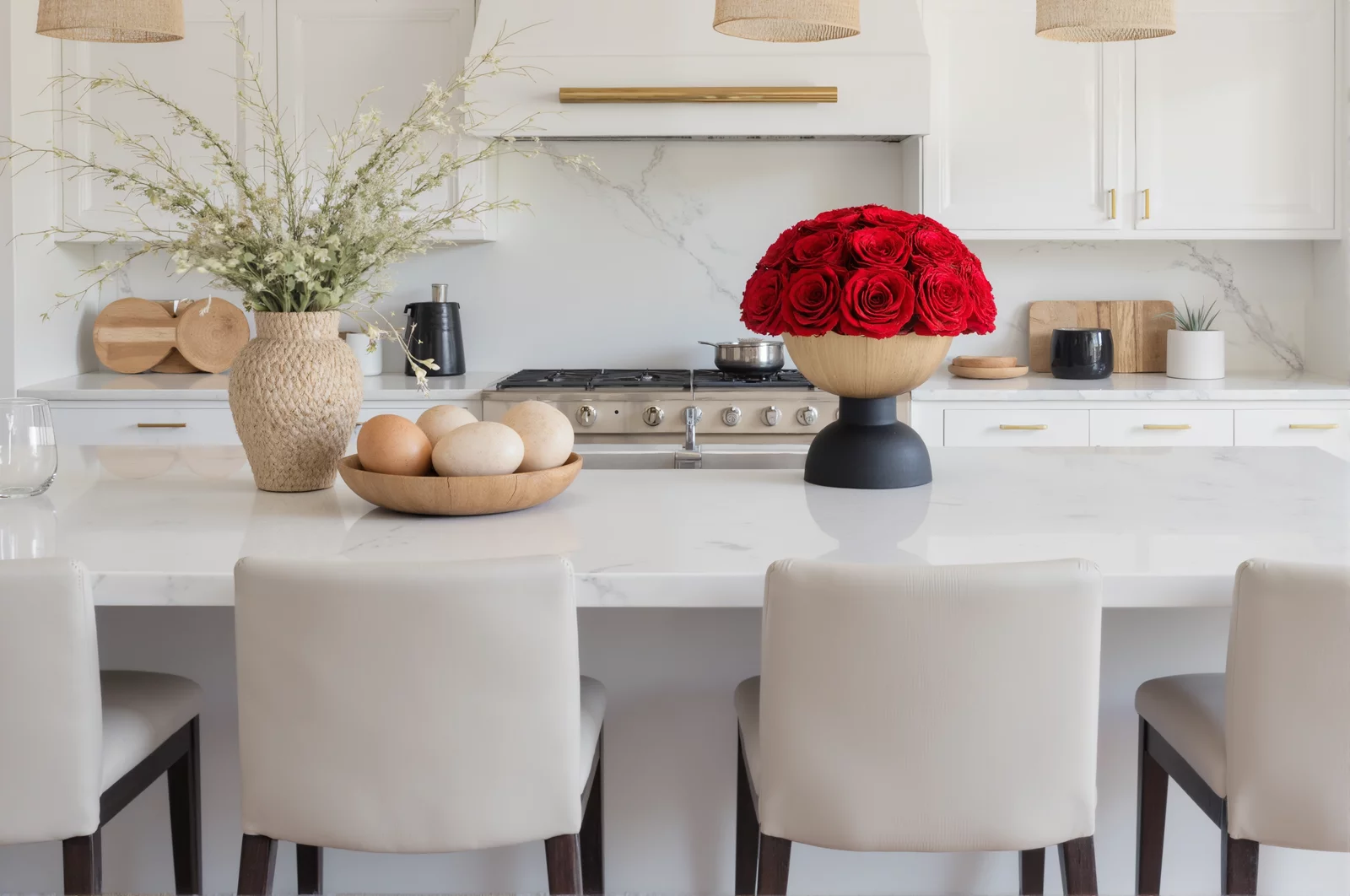 Elegant kitchen island with woven basket, gold vase, and red roses