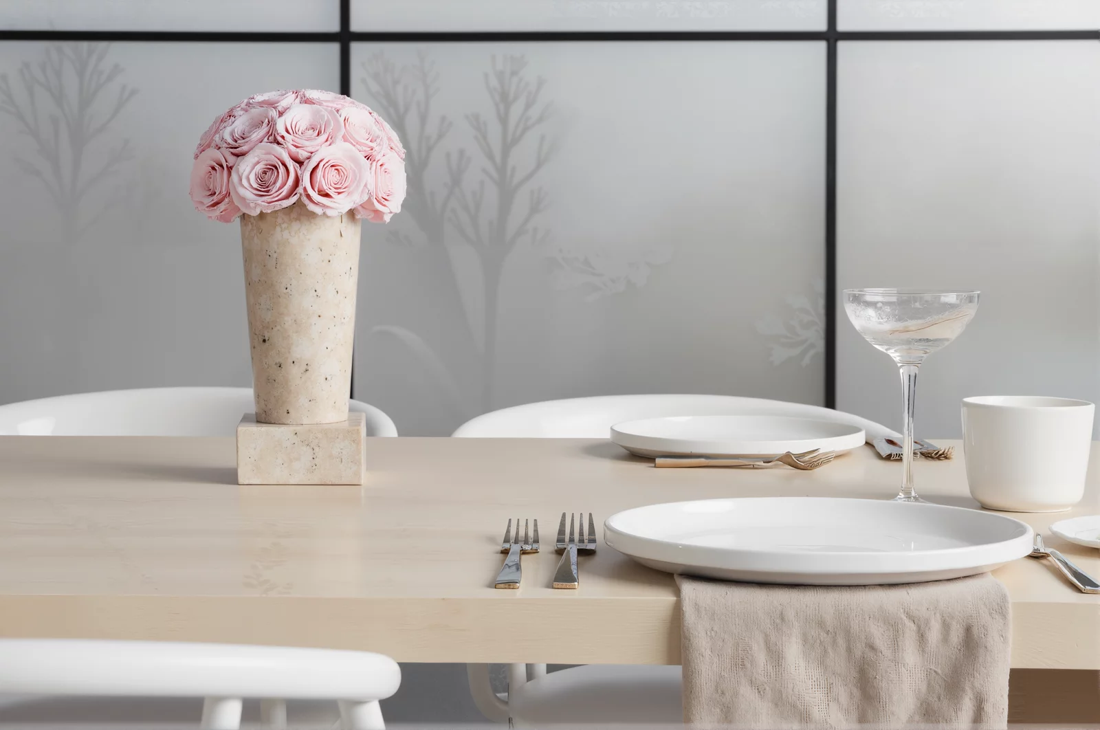 Minimalist dining table with pink paper rose centerpiece and frosted windows
