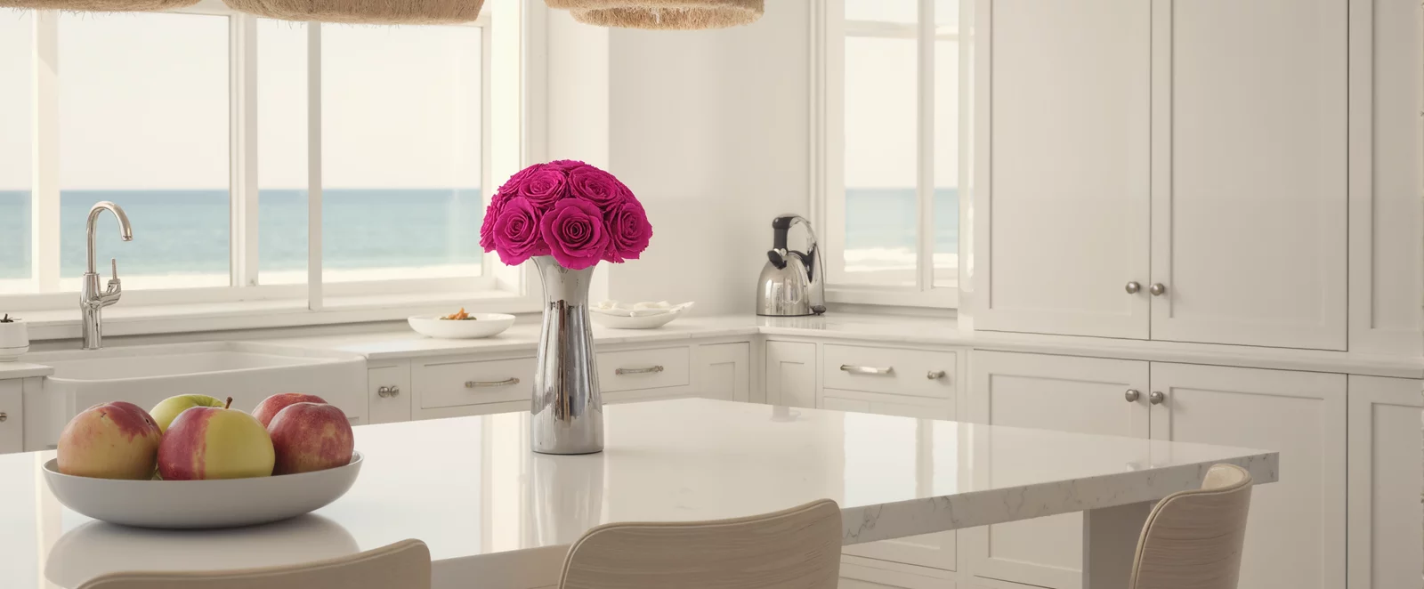 Bright kitchen with ocean view, pink roses, and stainless steel coffee maker