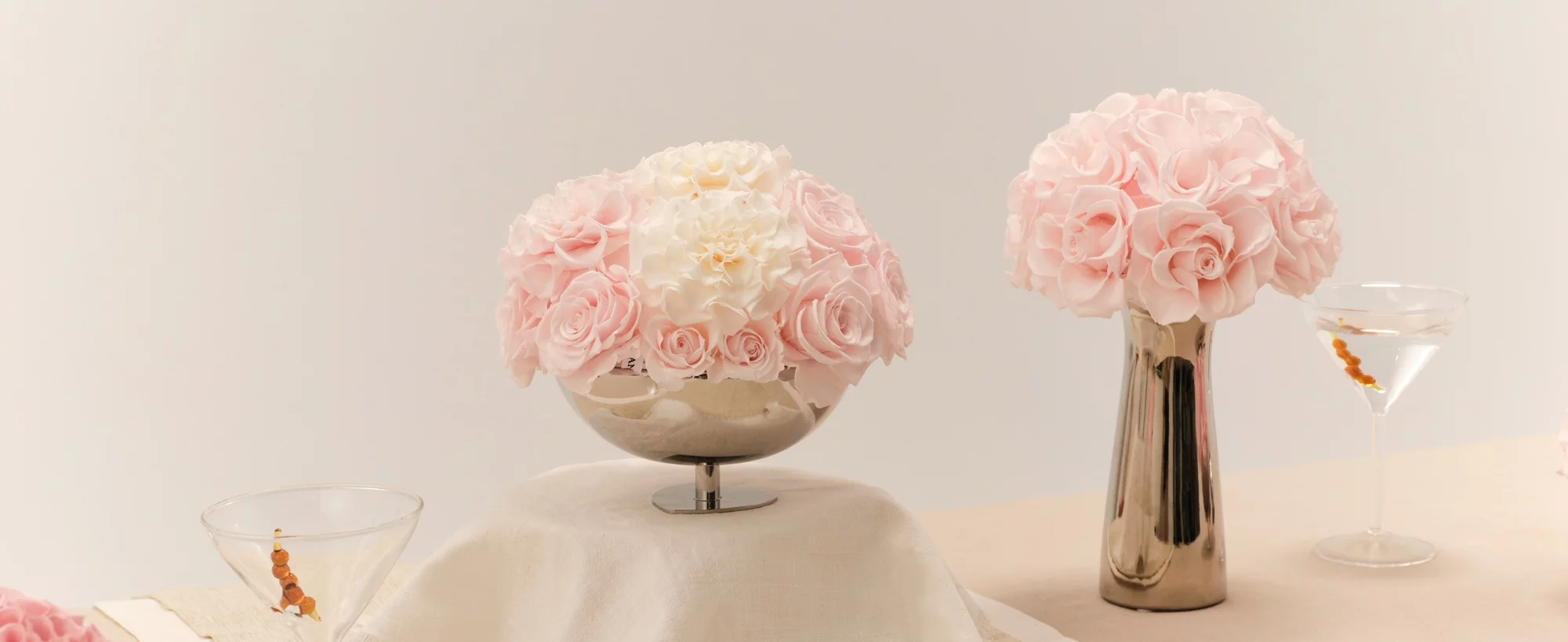 Elegant table setting with silver pedestal and pink roses