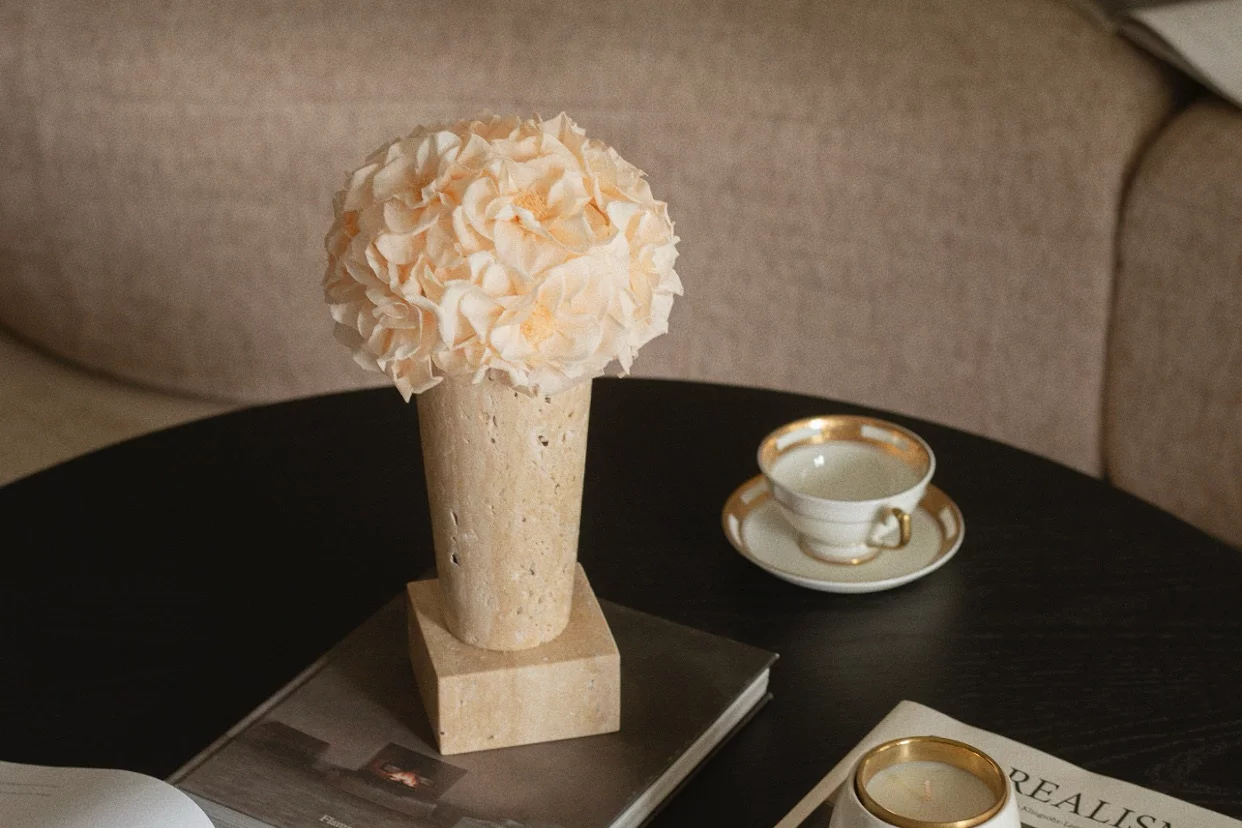 Minimalist living room with beige vase of peach flowers