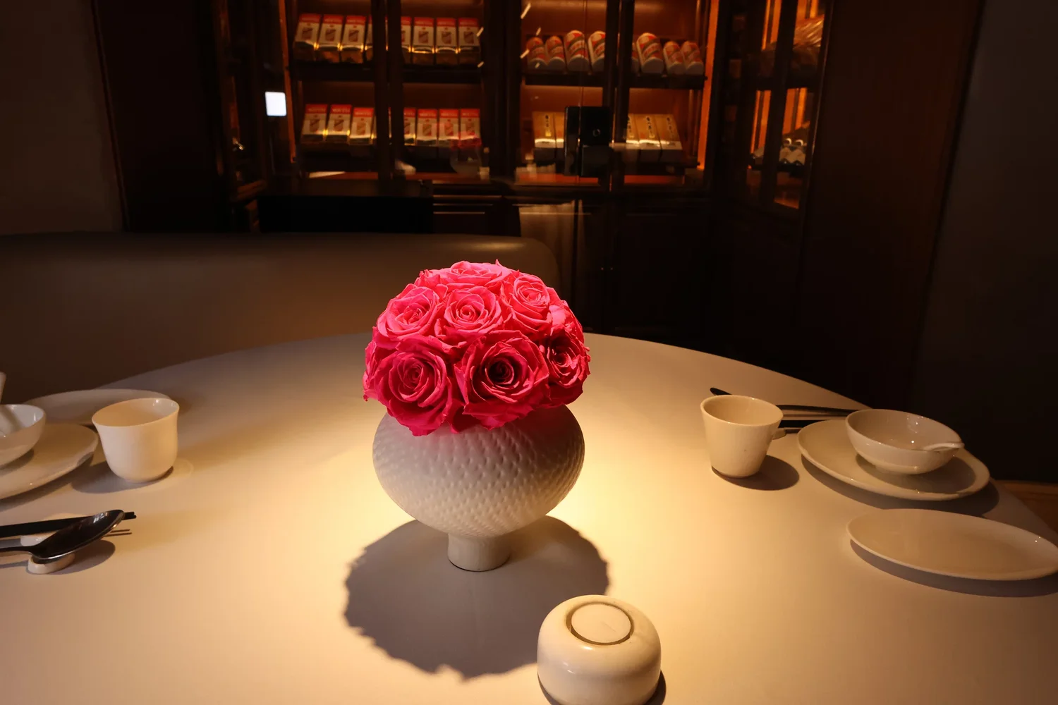 Upscale restaurant with white vase containing roses