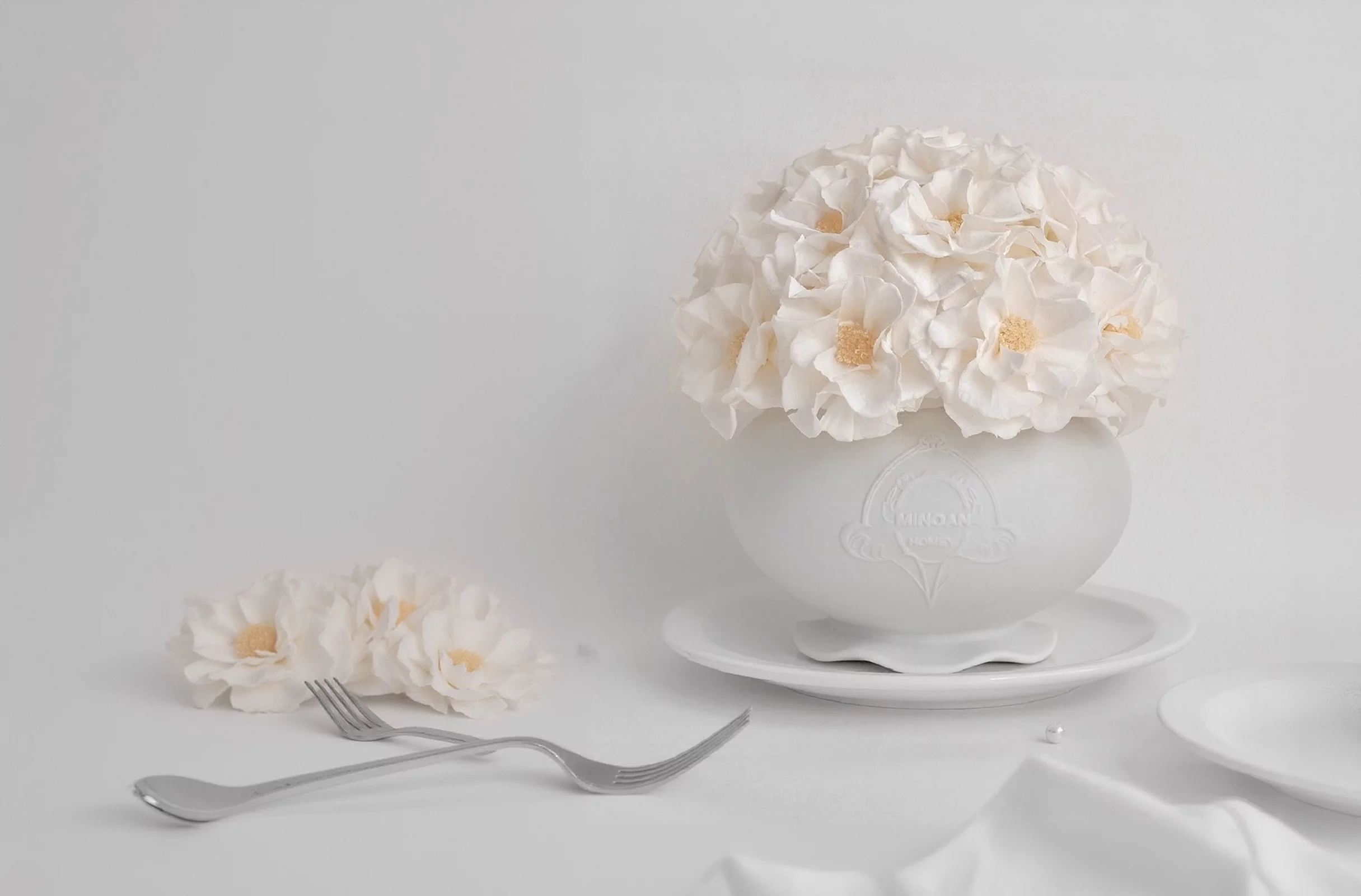 White ceramic vase with delicate floral pattern