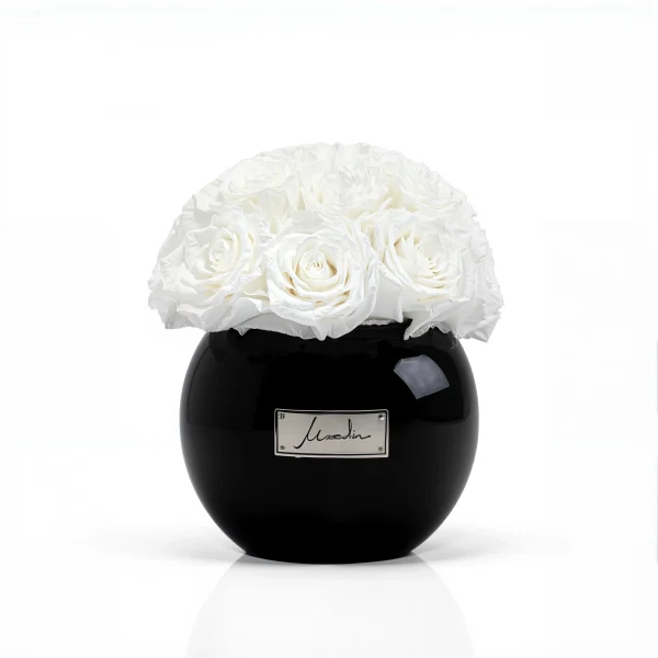 Luxury black ceramic vase with a refined cream lachaise label, showcasing pristine white roses in full bloom,