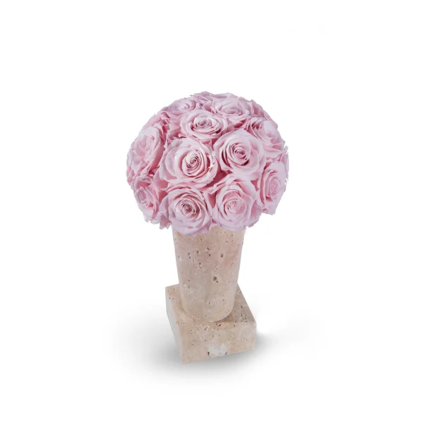 Bouquet of pink roses densely packed in light beige textured vase on matching square base against stark white background