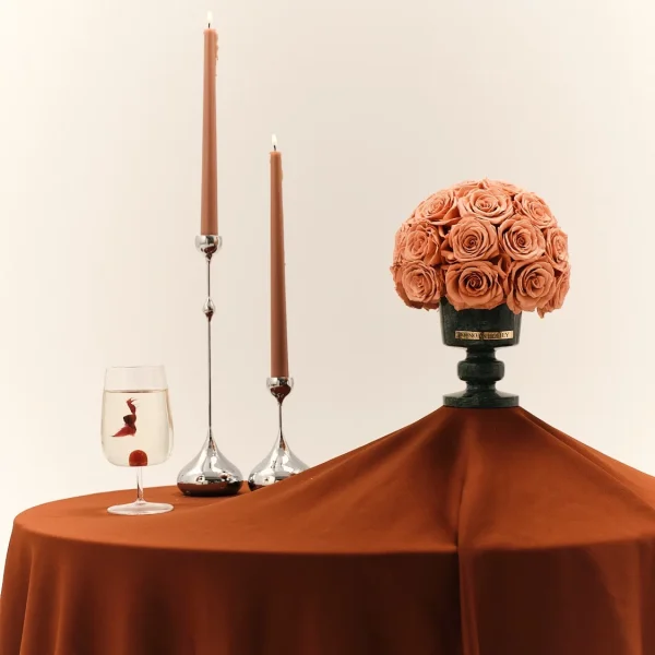 Elegant setup with tall candles and peach-colored roses