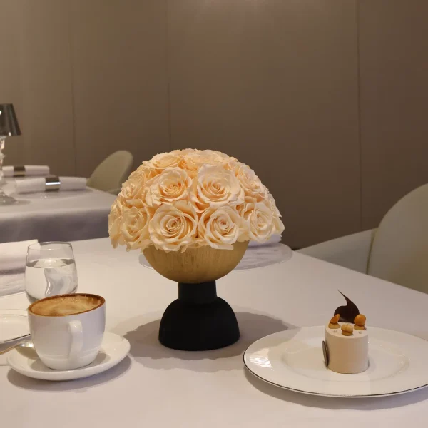 Light wooden vase with cream roses on black base