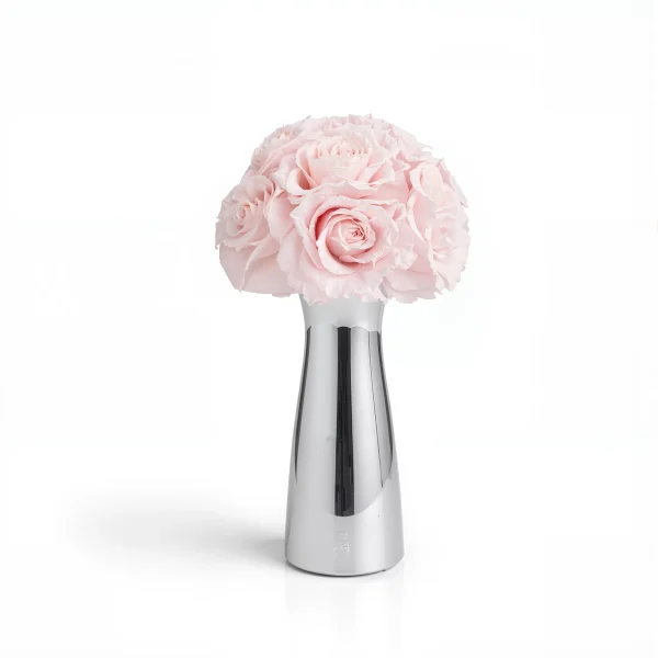 Pastel pink carnations in sleek metallic vase
